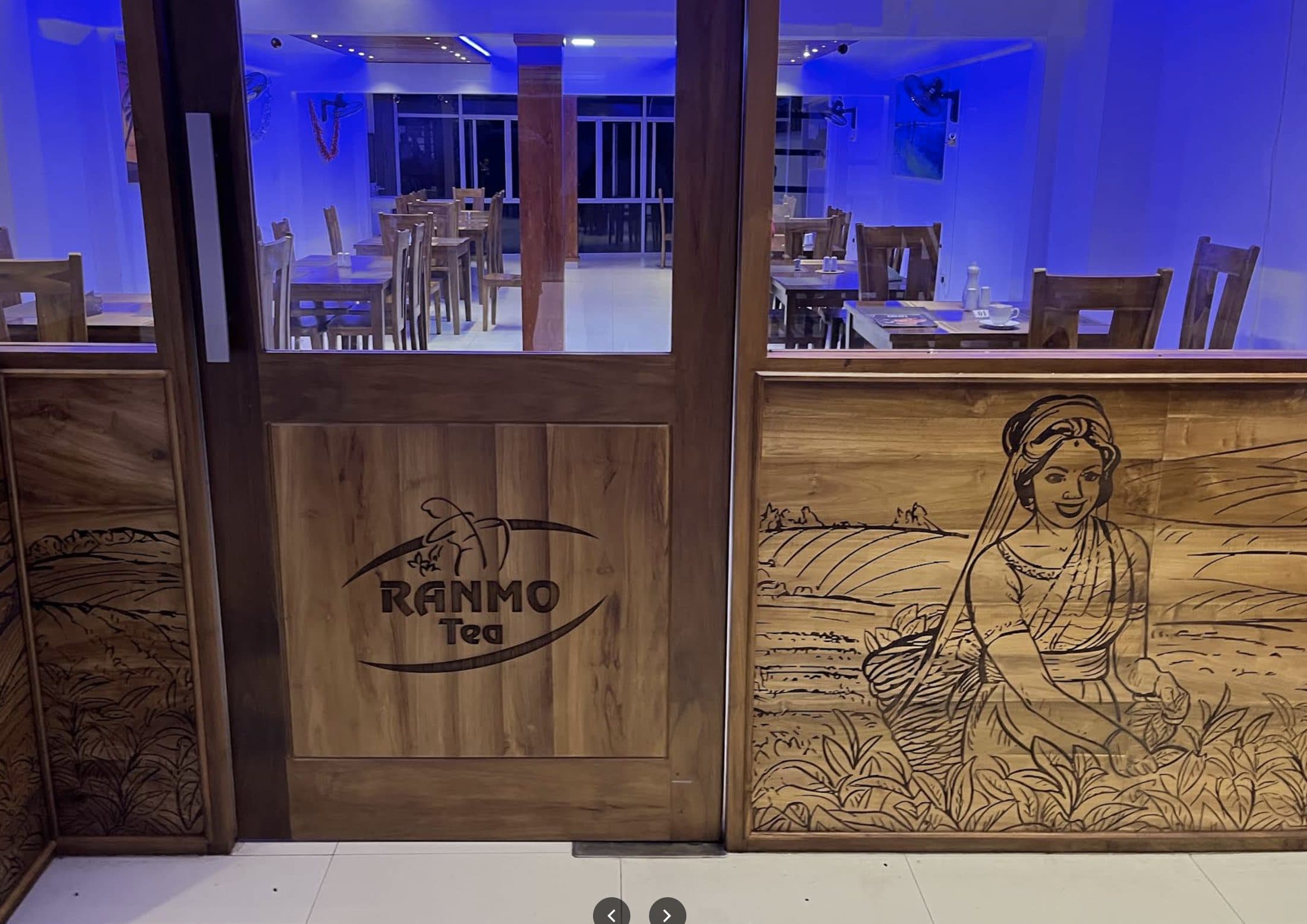 The hand-carved wood entrance mural at Ranmo, depicting Sri Lanka's tea country